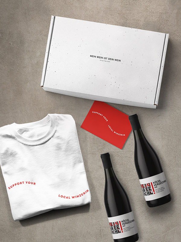 Geschenkkarton mit Aufschrift "Mein Wein ist Dein Wein", T-Shirt "Support Your Local Winzerin", 2 Weinflaschen und Geschenkkarte